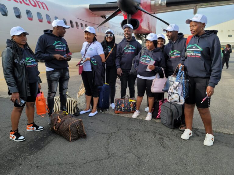 Ezekiel Ng'ang'a, Second From Left and his business partner Polly Kibe (in white) at Wilson Airport With His Team of Homes Heart Properties Employees.PHOTO/HHP